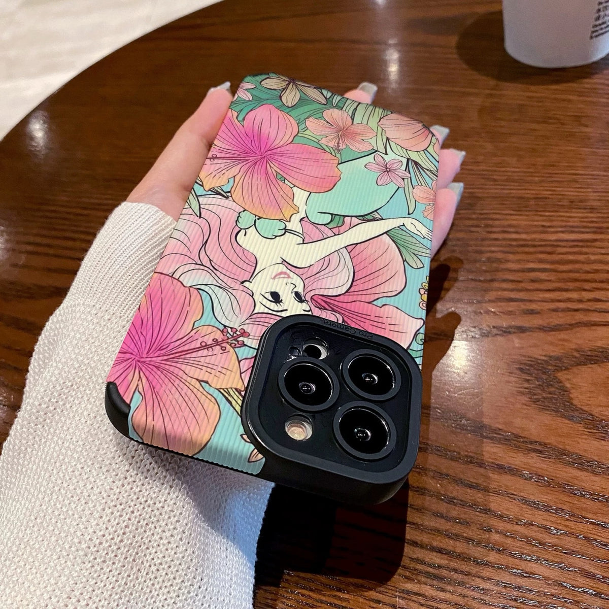 iPhone case with Ariel in floral and fairy design held by a hand on a wooden surface