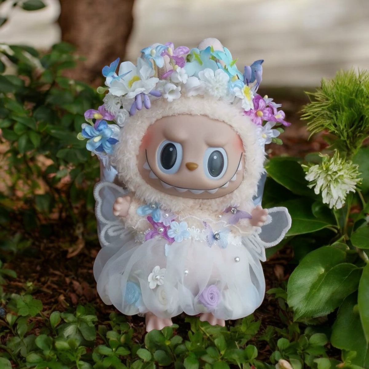Toy figure with floral headband and dress on a natural background