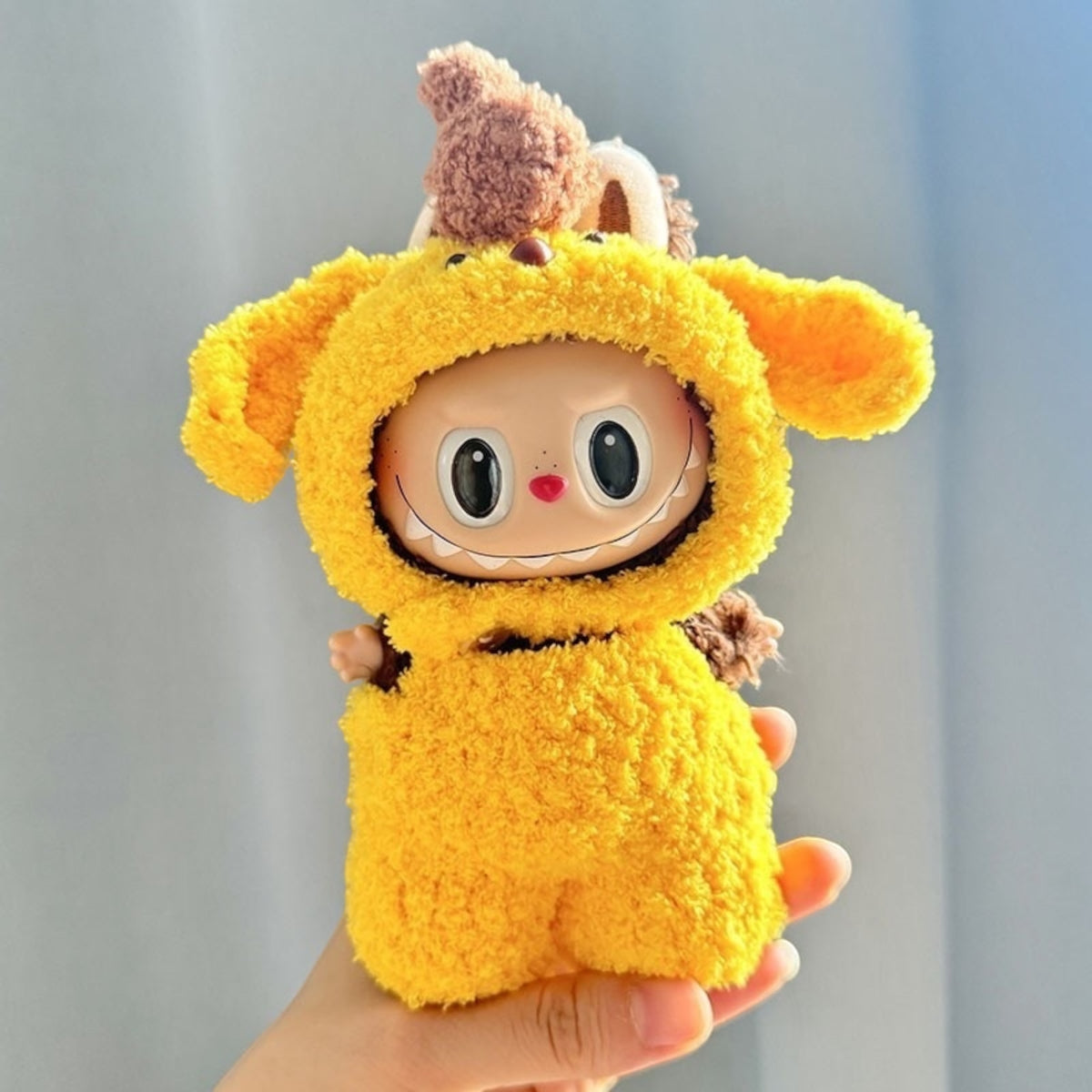 Transform your labubu into a lovable pup with this handmand costume! Perfect for versions 1, 2, and 3, this cute yellow outfit will surely bring a smile to faces worldwide. (Labubu figure not included). Woof! Cute-Puppy-costume_style_-_Handmand_Labubu_Doll_Outfit