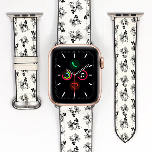 Black and white cartoon-print Apple Watch strap displayed with a smartwatch