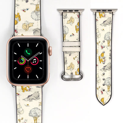 Close-up of a cream storybook character Apple Watch band with delicate woodland illustrations and silver-tone hardware.