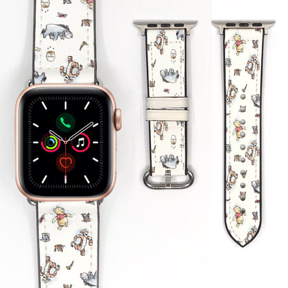 Close-up of a cream Winnie the Pooh watch band featuring Pooh, Tigger, Eeyore, and storybook-inspired illustrations.