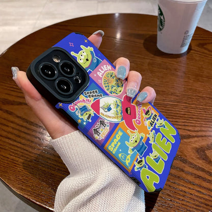 Colorful phone case with Toy Story alien design held by a person on a wooden table with a Starbucks cup in the background.