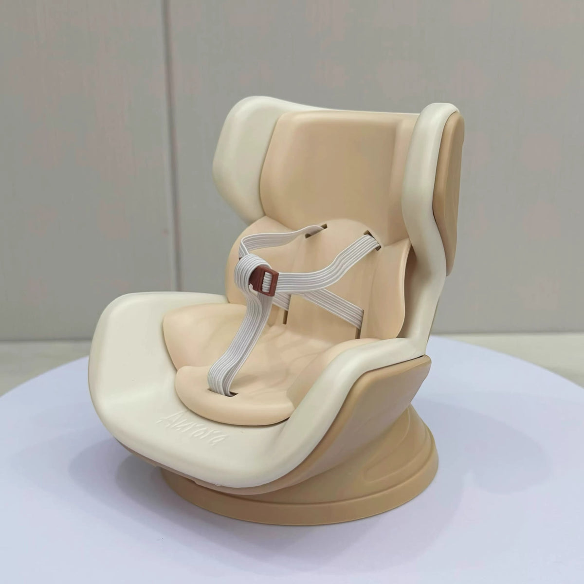 Beige baby car seat with straps on a white surface