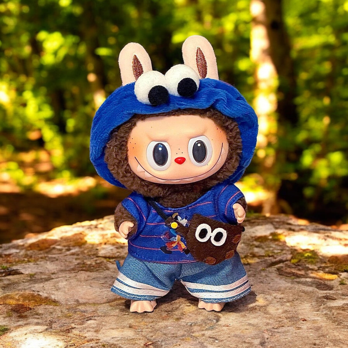 A Blue Cookie Monster Costume outfits on Labubu 17cm Doll with forrest background