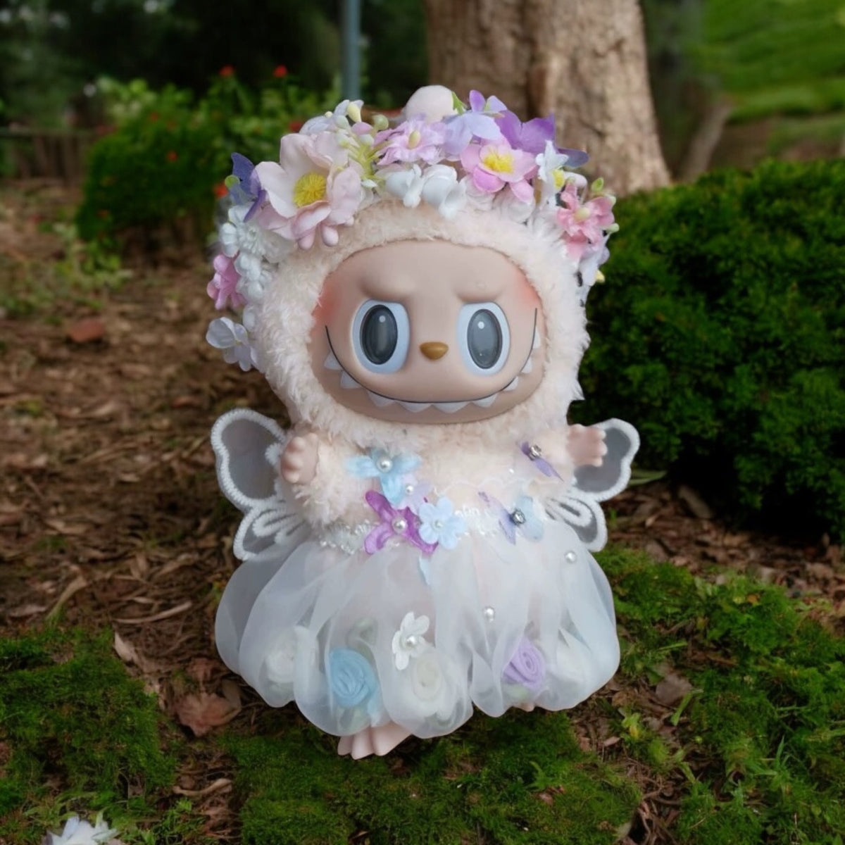 Plush toy with floral headband and dress on grass