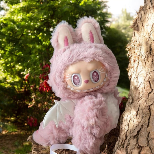 Pink labubu outfit plush toy with pink zimomo dinosaurs outfit peeking from behind a tree in a garden setting