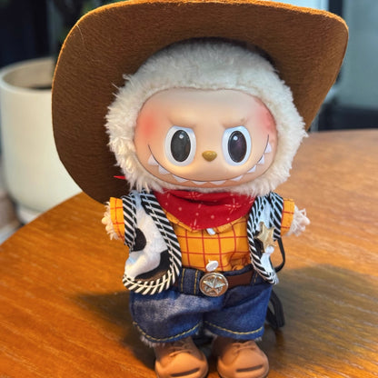 Toy figure of a cowboy woody with a brown hat and orange shirt on a wooden surface.