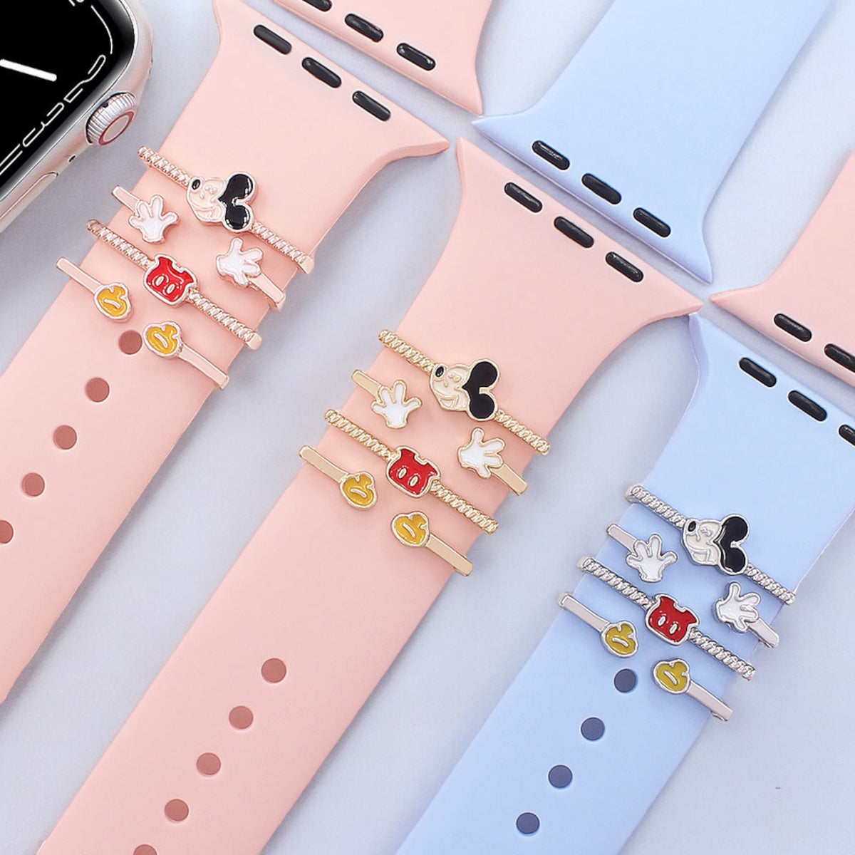 Smartwatch with decorative band featuring vintage mickey mouse designs on a light gray background