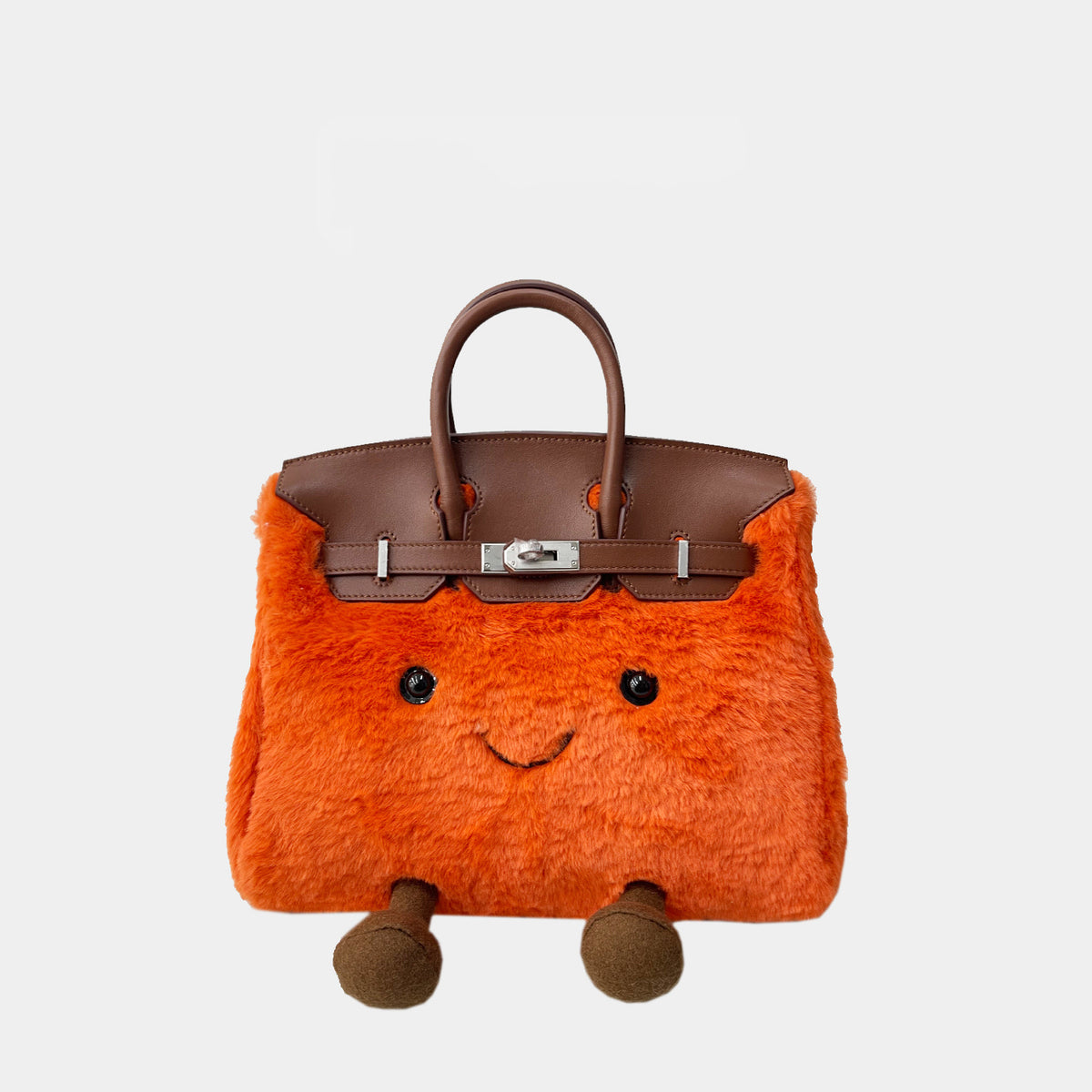Mini orange plush bag with a smiley face and brown handles