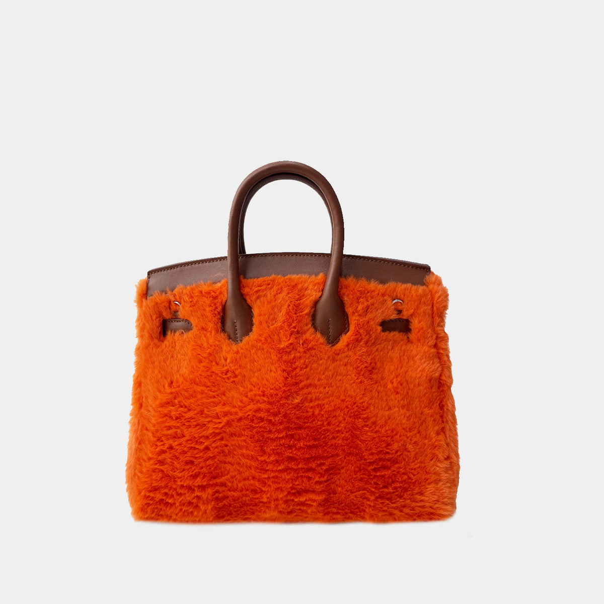 Back view of a mini orange fluffy handbag with brown character feet